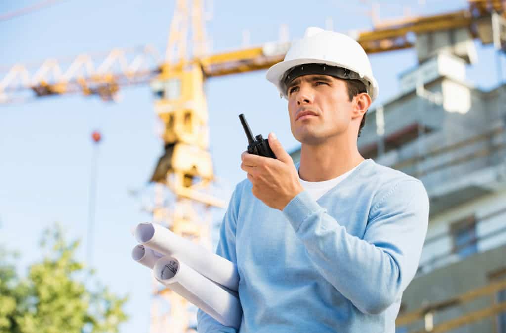 man at construction site with walkie talkie
